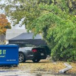 car parked near dumpsters