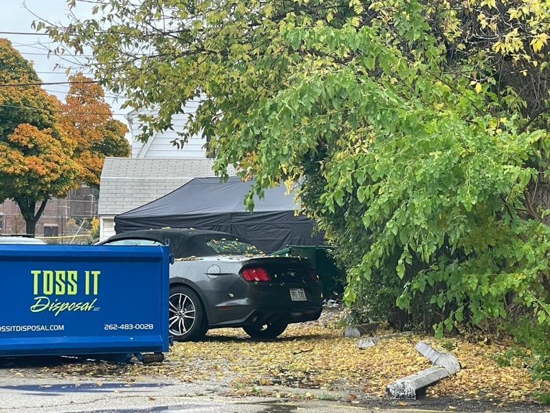 car parked near dumpsters