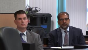 Timothy Ferriter and his attorney watch videos played in court