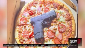 Cops find gun on pizza.