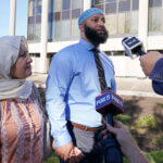 Adnan Syed walks with his mother.