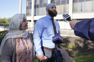 Adnan Syed walks with his mother.