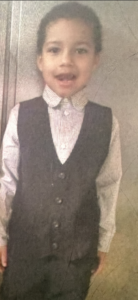 a young child in a suit