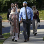 Adnan Syed walks with his mother.