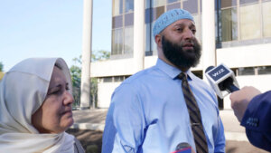 Adnan Syed walks with his mother.