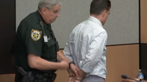 A man is handcuffed in court