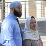 Adnan Syed walks with his mother.