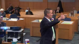 an attorney gestures as he speaks to the jury