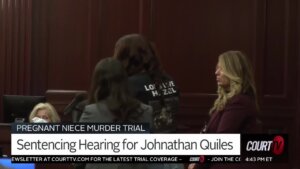 A woman stands and delivers a victim impact statement in court