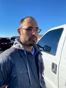 photo of Hanme Clark standing next to a white truck