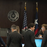 Lawyers approach the bench in court