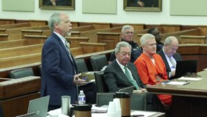 Creighton Waters speaks in court, while Alex Murdaugh sits with his attorneys in the background