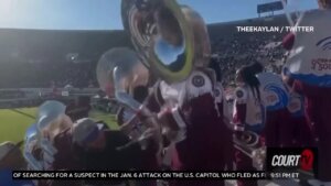 Tuba player punches heckler at college football game.