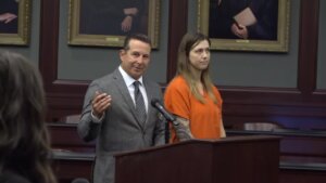 Jose Baez stands with his client Shanna Gardner