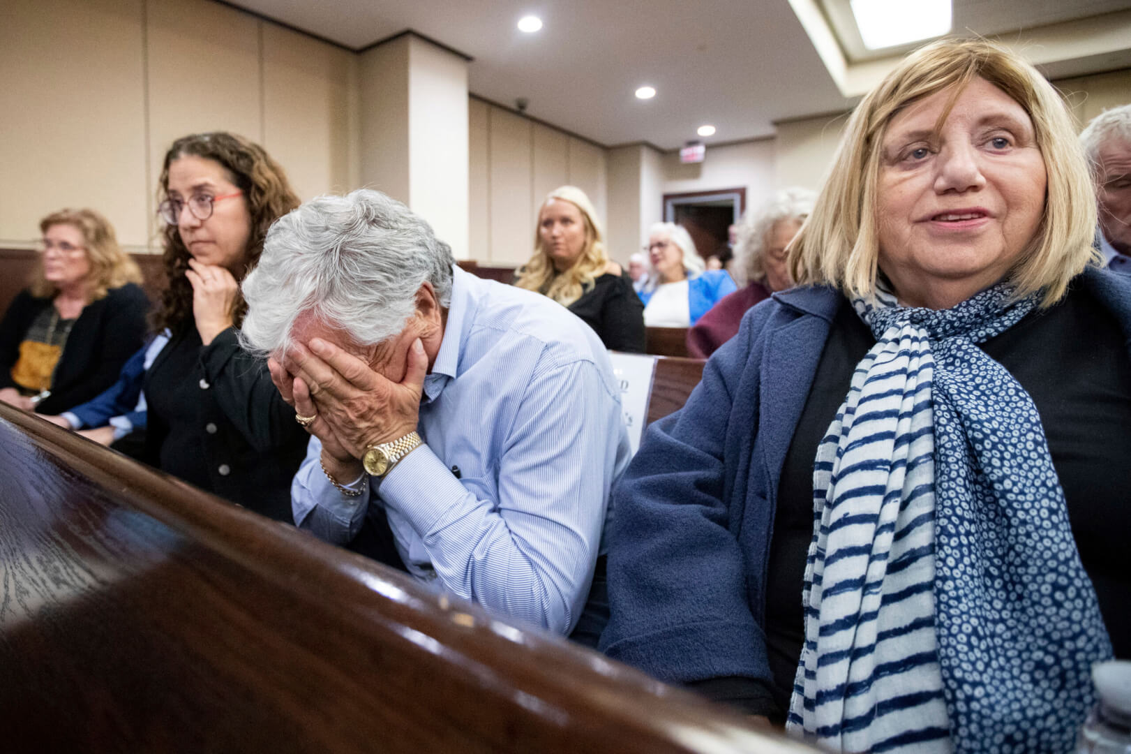 people react with emotion in the courtroom gallery