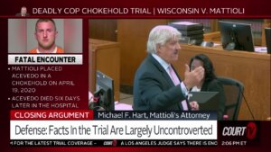 A man with white hair speaks to the jury