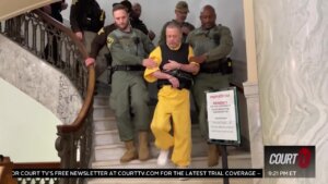 Richard Allen walks down the stairs with police