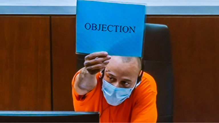 Darrell Brooks holding objection sign