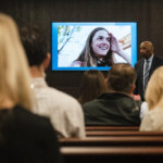 Anna Moriah Wilson's photo is displayed on the screen as state attorney Rickey Jones addresses the jury during the sentencing portion of Kaitlin Armstrong's murder trial at the Blackwell-Thurman Criminal Justice Center on Friday, Nov. 17, 2023. Armstrong was found guilty of killing Anna Moriah Wilson in May 2022.