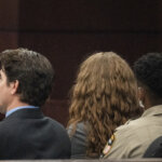 Kaitlin Armstrong sits with her attorneys in court