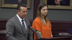 Jose Baez stands with his client Shanna Gardner