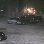 Still from surveillance video shows person of interest and two cars