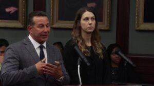 Jose Baez stands with Shanna Gardner in court