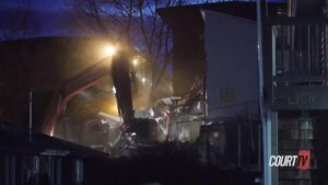 Construction equipment tears down a building