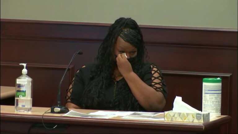 a woman cries on the witness stand