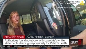 Gabby Petito sits in the back of a police car