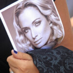A mourner carries a program at the funeral for Reeva Steenkamp