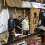 Hasidic Jewish students observe as law enforcement establishes a perimeter