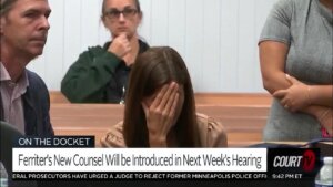 Tracy Ferriter covers her face with her hand in court