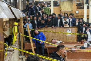 Hasidic Jewish students observe as law enforcement establishes a perimeter