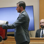 Prosecutor holds up a red cooler
