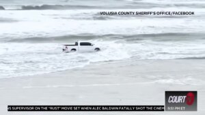 Pickup truck drives into ocean.