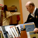 Court officer Ron Delisle carries evidence