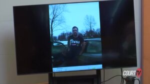 Adam Montgomery is seen in bodycamera video played in a monitor