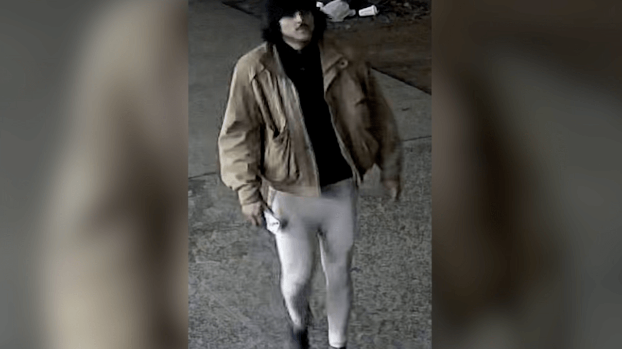 Surveillance photo of a man walking down the street