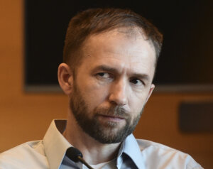 A man looks at the camera while testifying