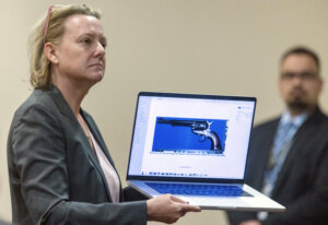 Kari Morrissey shows defense attorney Jason Bowles a picture of a firearm