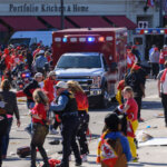 Ambulance drives through a crowd