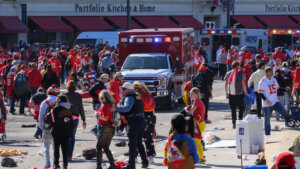 Ambulance drives through a crowd