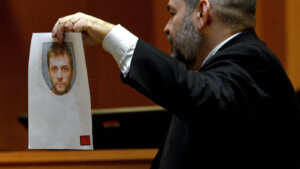 Benjamin Agati shows a mugshot of Adam Montgomery to a witness