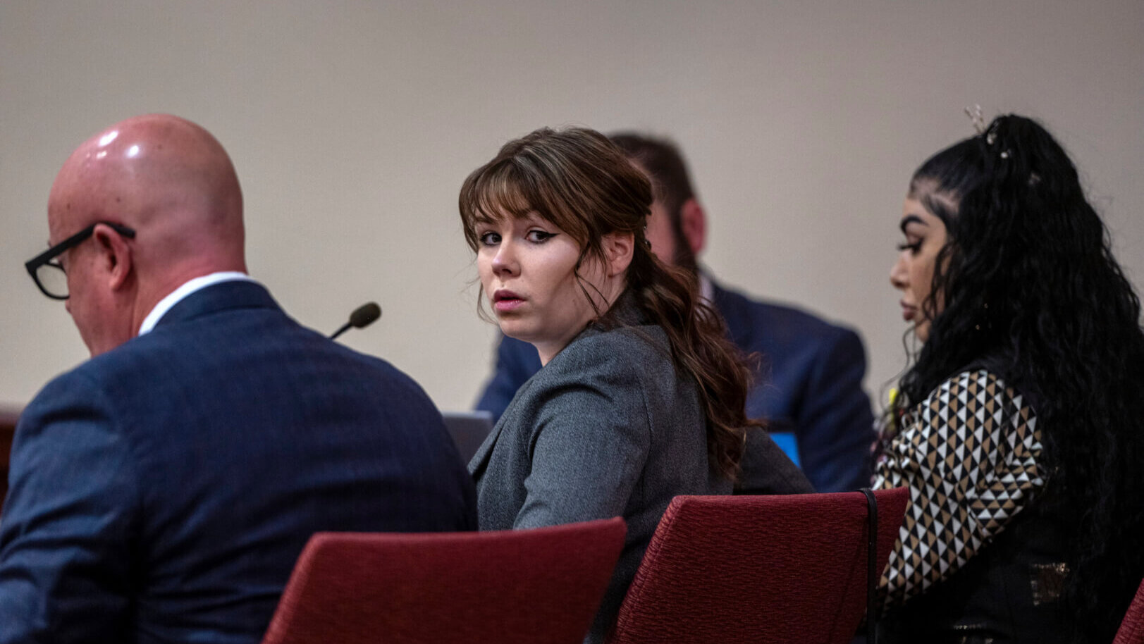 Hannah Gutierrez, center, sits with her attorney Jason Bowles, left,