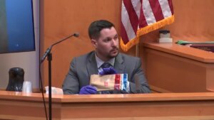 Joseph Tucker displays evidence bag in court