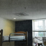 photo of a room with bunk bed and vent in ceiling