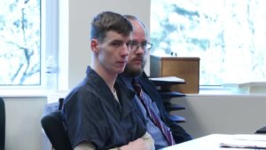 Paul Ferguson and his attorney sit in court