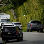 A federal investigator walks on a street