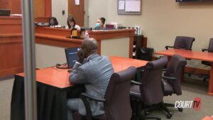 an empty chair at a defense table in court